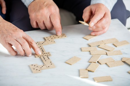 Senior Couple Playing Dominoes At Tableの写真素材
