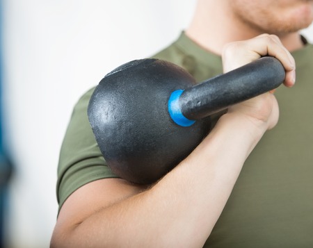 Male Athlete Lifting Kettlebellの写真素材