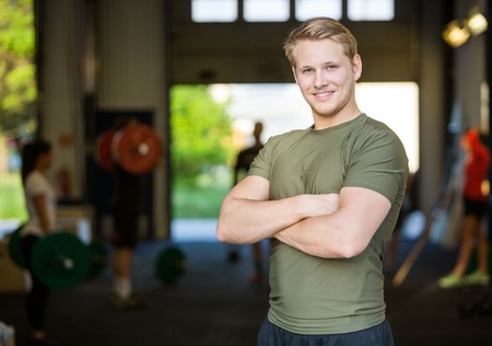Smiling Male Athlete Standing At Gymの写真素材
