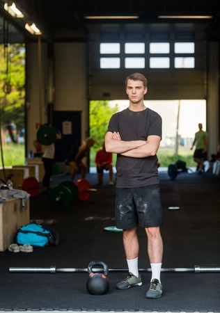 Fit Man With Arms Crossed Standing At Healthclubの写真素材