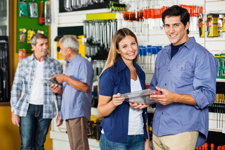 Happy Couple Holding Tool Set In Hardware Store