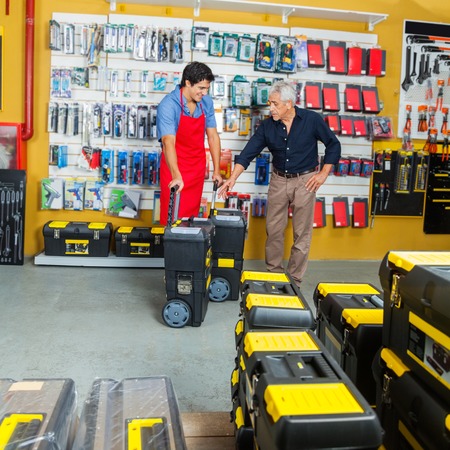 Salesman Showing Tool Cases To Customer In Storeの写真素材