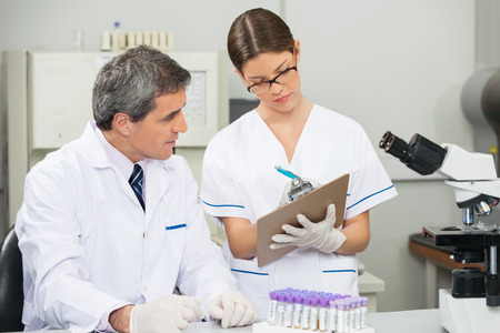 Scientist Working With Colleague In Medical Labの写真素材