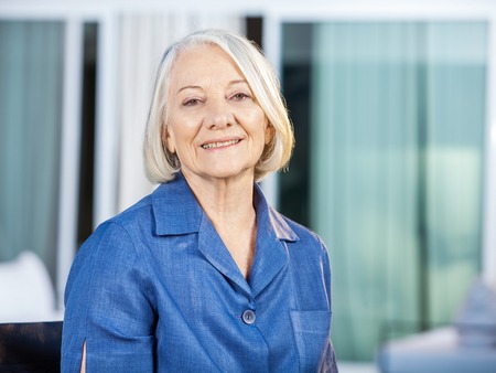 Happy Senior Woman At Nursing Home Yardの写真素材