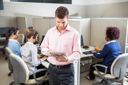 Businessman Using Tablet Computer In Call Centerの写真素材