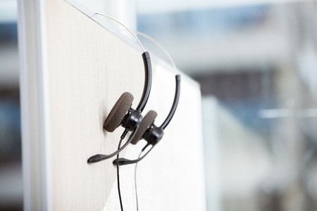 Headphones Hanging In Empty Officeの写真素材