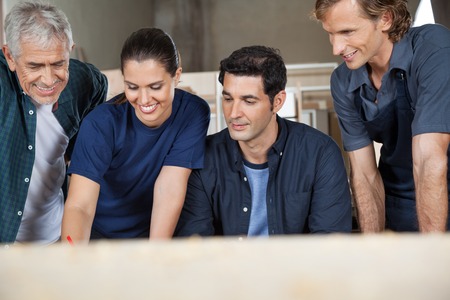 Carpenters Working In Workshopの写真素材