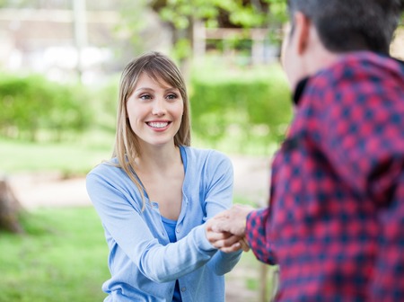 Happy Woman Holding Hand Of Boyfriendの写真素材