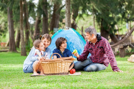 Family With Picnic Basket At Campsiteの写真素材