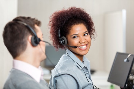 Customer Service Representatives Talking In Call Centerの写真素材
