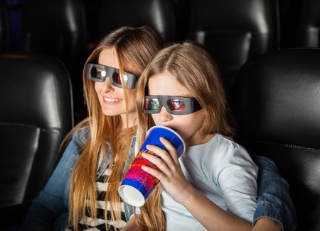 Mother And Daughter Watching 3D Movie In Theater