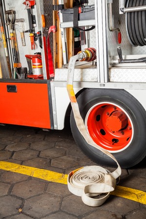 Water hose connected to truck at fire station