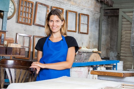 Portrait of smiling female worker smiling in paper factoryの写真素材