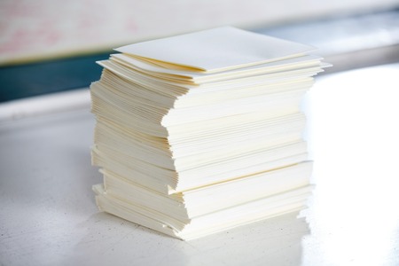 Closeup of stacked papers on table in factory