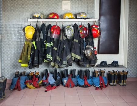Firefighter suits and gear arranged at fire stationの写真素材