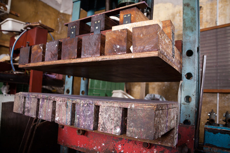 Closeup of paper press machine in factory