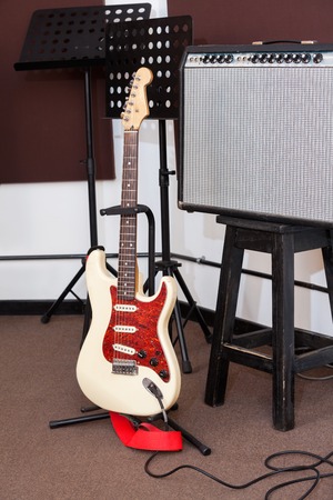 Electric guitar and tuner in recording studio