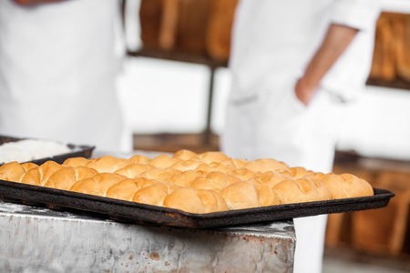 Closeup of breads on baking tray at bakery