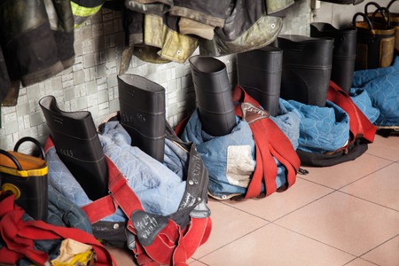 High angle view of firefighter's boots on tiled floor at fire stationの写真素材
