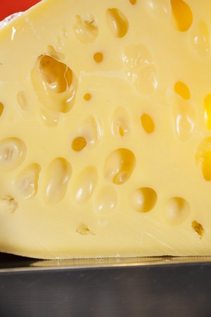 Closeup of cheese pieces displayed in shop at supermarketの写真素材