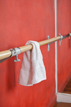 Closeup of white napkin hanging on bar by wallの写真素材