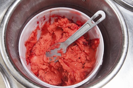 Closeup of strawberry ice cream in container at shopの写真素材