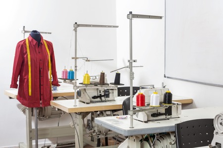 Shirt on mannequin by workbenches in sewing factoryの写真素材