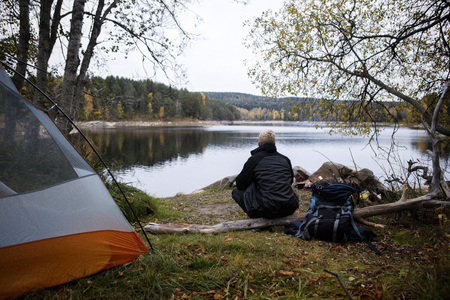 Male Hiker Enjoying The View Of Lake At Campsiteの写真素材