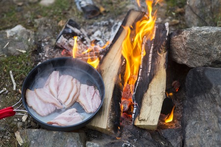 Fresh Meat Being Cooked Over Campfireの写真素材
