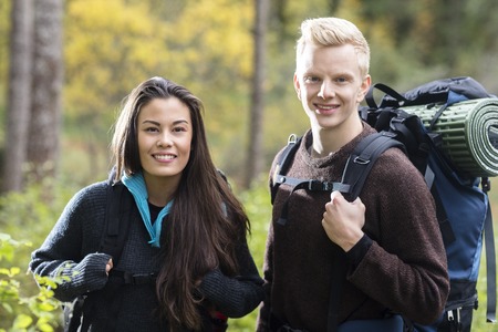Portrait Of Couple With Backpacks In Forestの写真素材