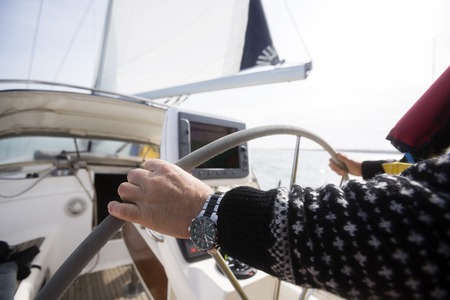 Mans Hands Steering Wheel Of Yachtの写真素材
