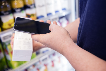 Cropped Image Of Man Scanning Barcode Through Smart Phoneの写真素材