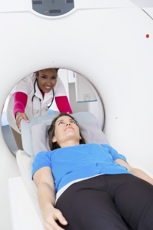 Confident Doctor Preparing Patient For CT Scan In Hospitalの写真素材