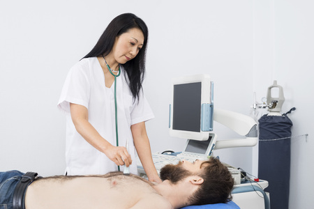 Doctor Examining Patient With Ultrasound Machineの写真素材