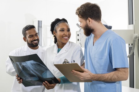 Medical Professionals With Chest X-ray And Clipboard In Hospitalの写真素材