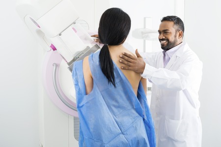 Doctor Assisting Mature Woman Undergoing Mammogram Testの写真素材