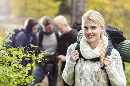 Female Hiker With Friends Discussing In Backgroundの写真素材