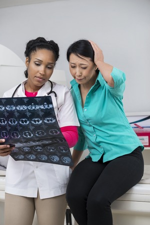 Doctor Showing X-ray Report To Worried Patient In Hospitalの写真素材