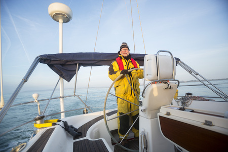 Portrait Of Man Sailing Yacht In Seaの写真素材