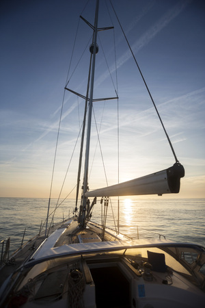 Luxury Yacht Sailing In Sea During Sunsetの写真素材