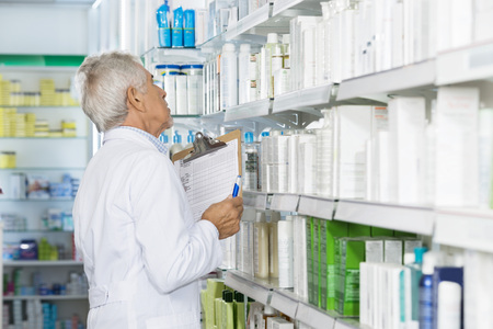 Male Chemist Counting Stock In Pharmacyの写真素材