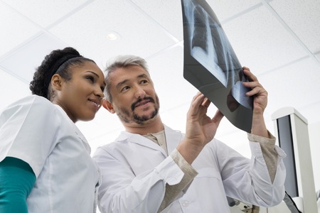Radiologists Analyzing Chest X-ray In Examination Roomの写真素材