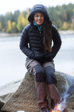 Woman Wearing Winter Jacket During Lakeside Campingの写真素材