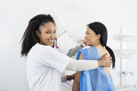 Female Doctor Assisting Woman Undergoing Mammogram X-ray Testの写真素材