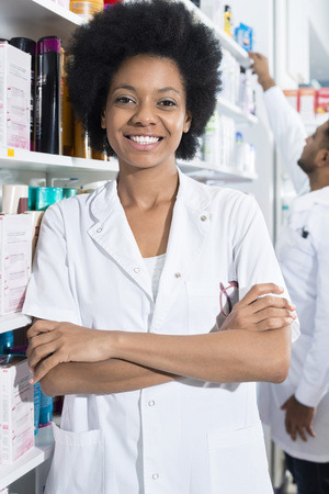 Confident Female Pharmacist With Arms Crossed In Pharmacyの写真素材