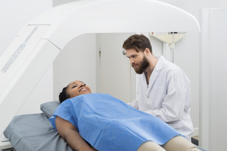Doctor Looking At Female Patient Undergoing Breast Checkupの写真素材
