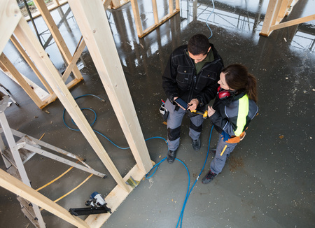 High Angle View Of Workers With Digital Tablet At Siteの写真素材