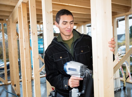 Male Carpenter Nailing Woodの写真素材