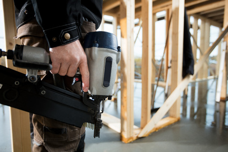 Midsection Of Professional Carpenter Holding Drill Machineの写真素材