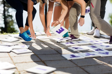 Low Section Of Business Team Solving Crossword Puzzleの写真素材
